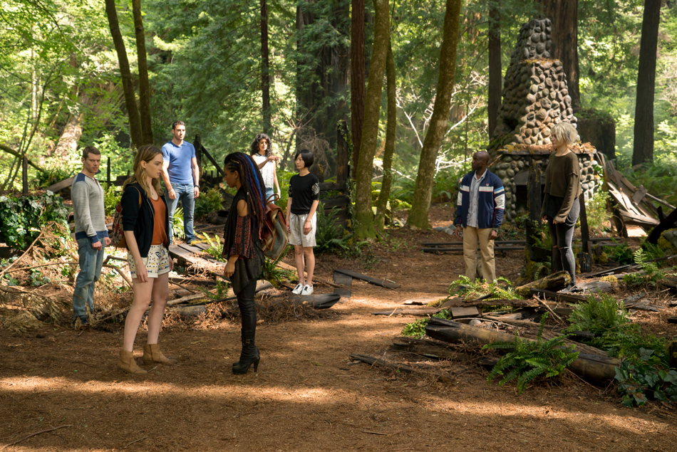 A still from the Netflix show Sense8, where some of the cast are stood out in the woods.